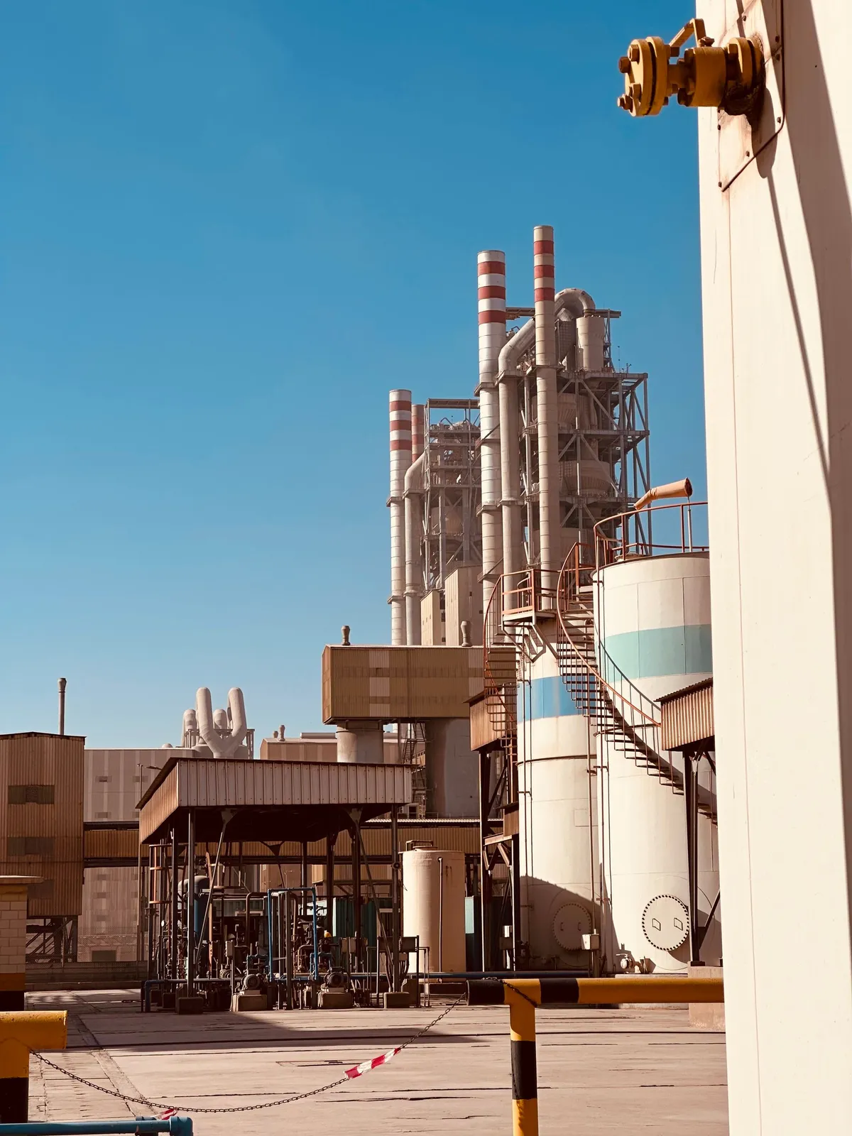 Cement plant with silos in Saudi Arabia under clear sky