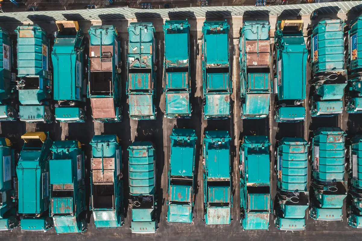 Aerial view of refuse collection trucks parked at a depot